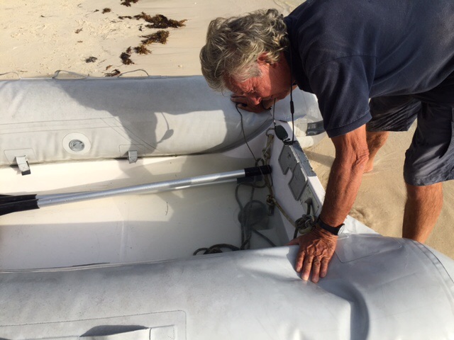 Our skipper, Ian, draining the dinghy on the beach