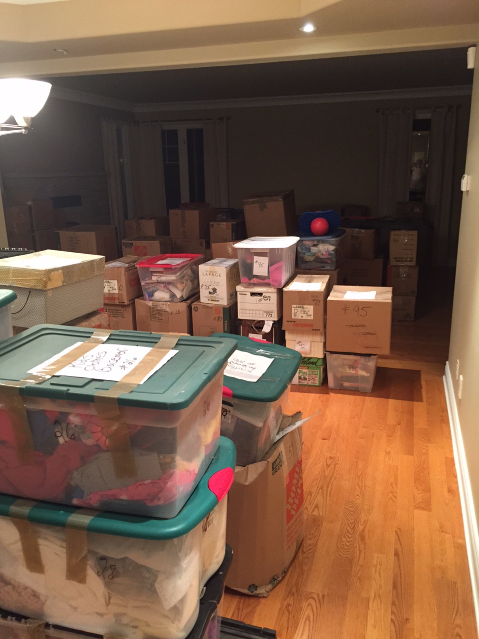Living room full of our belongings in boxes ready to be sold, thrown out, or given away