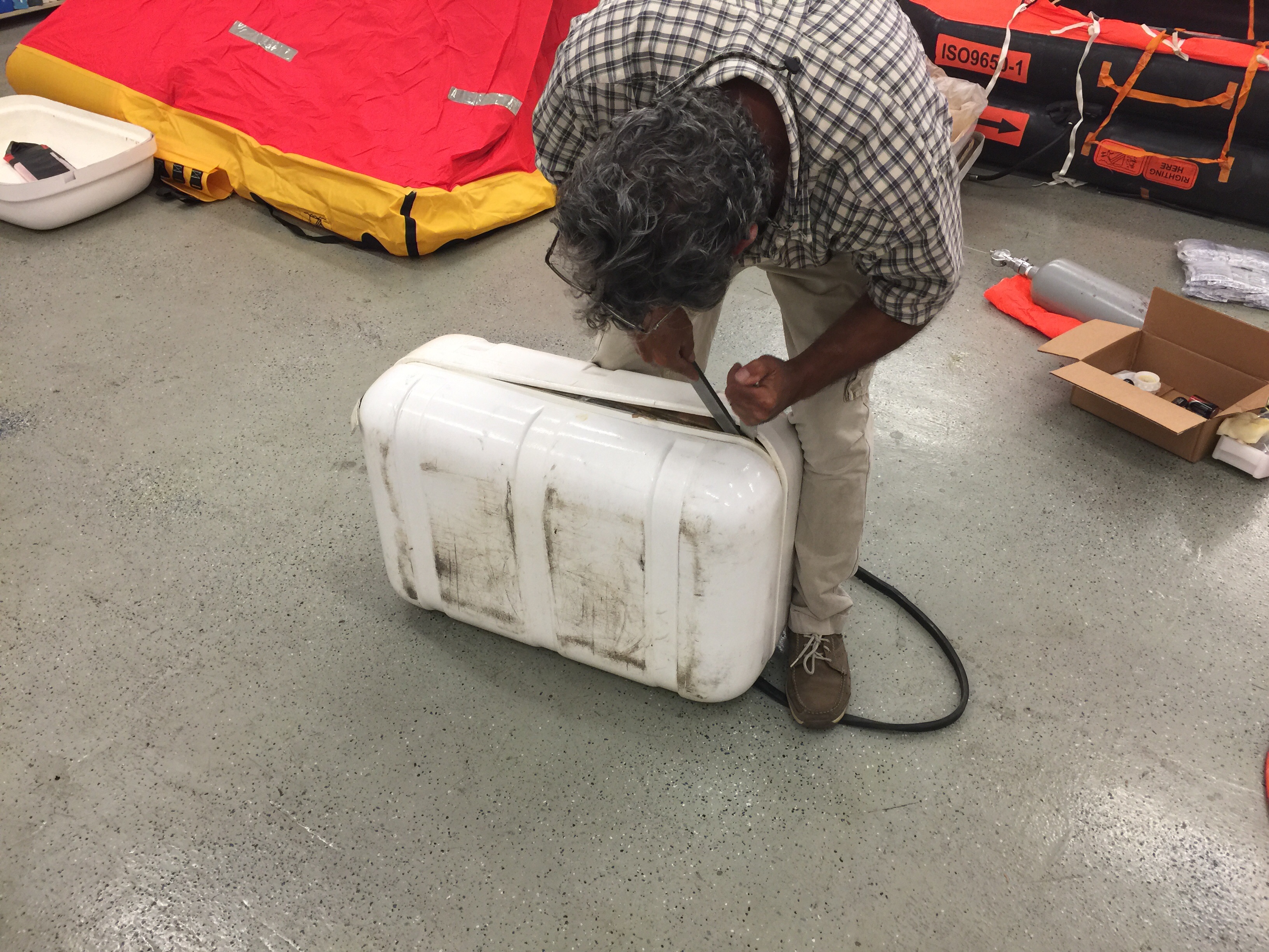 Yusri Jadallah of Solution One Maritime unpacks our life raft.