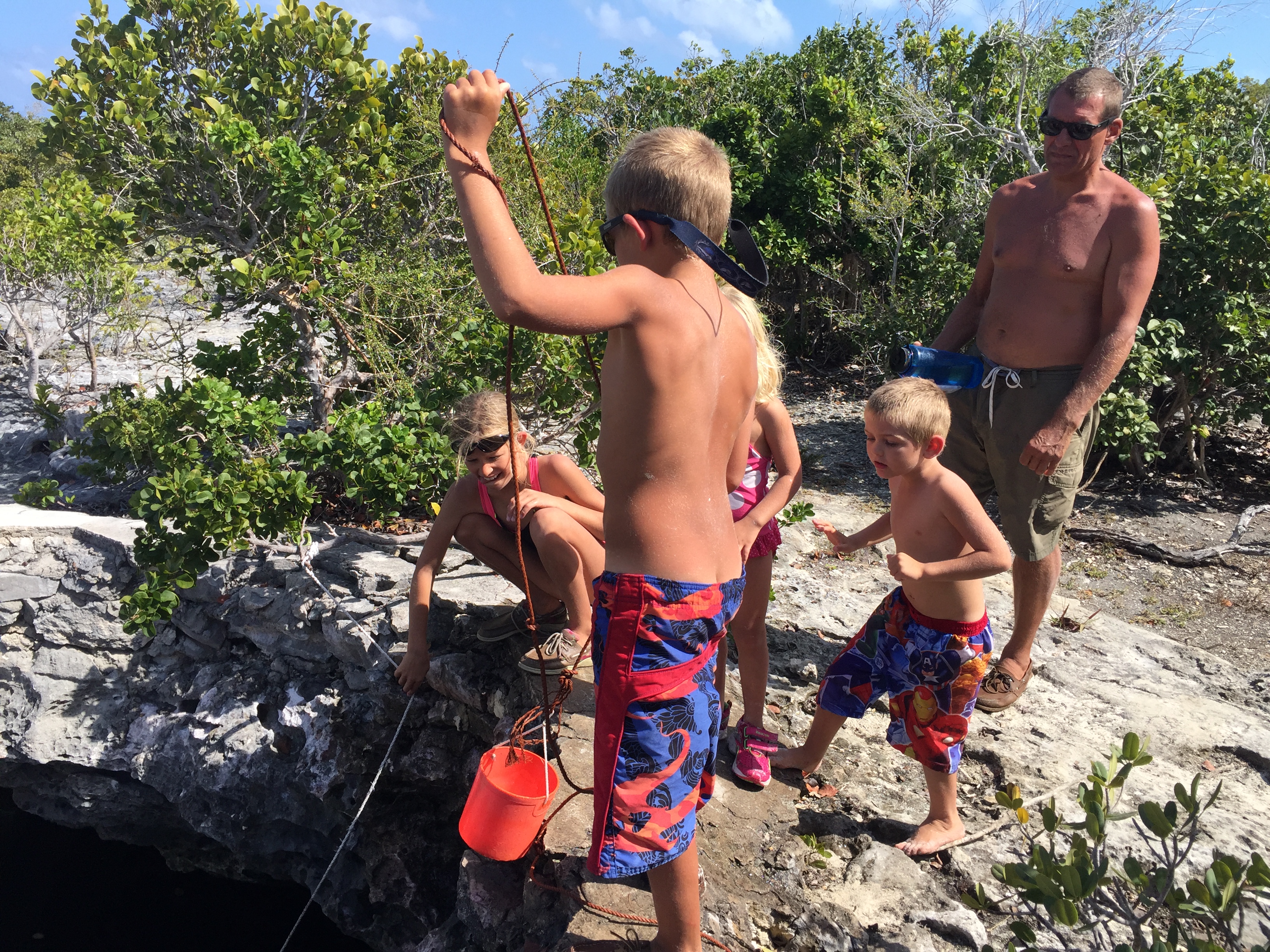 Boat Kids from SV Aphrodite and Rick at a well on Shroud Cay, Bahamas