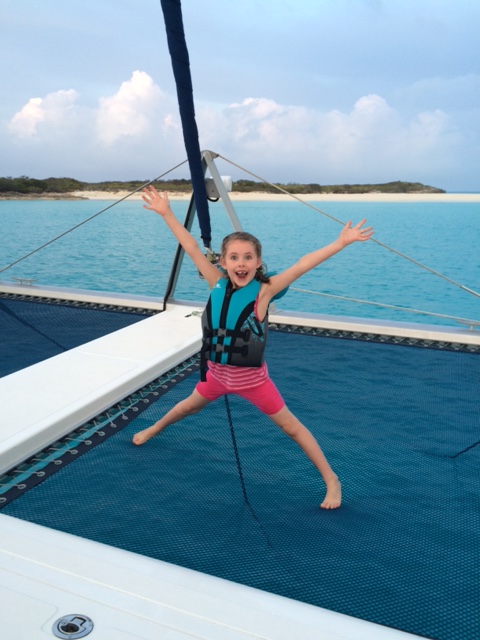 My neice Emily on our trampoline of our St. Francis 50 catamaran while she was visiting and sailing with our family in the Jumentos, Bahamas