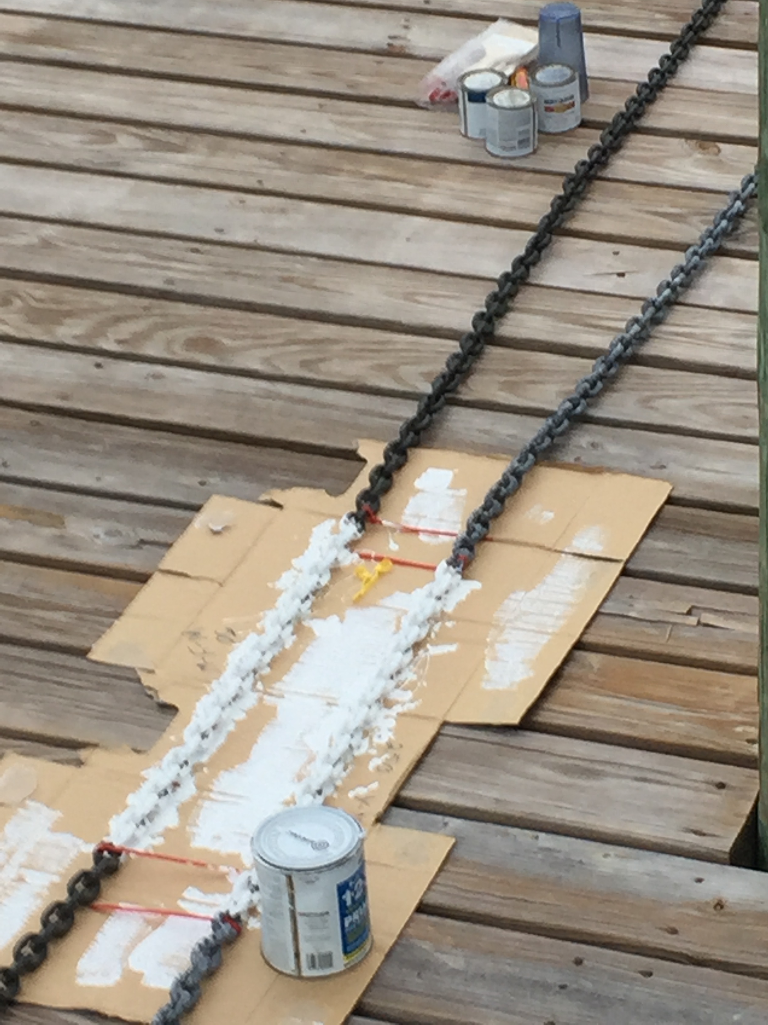 Painting our anchor chain to mark it for depth in 25 foot segments on the dock at George Town, Bahamas.