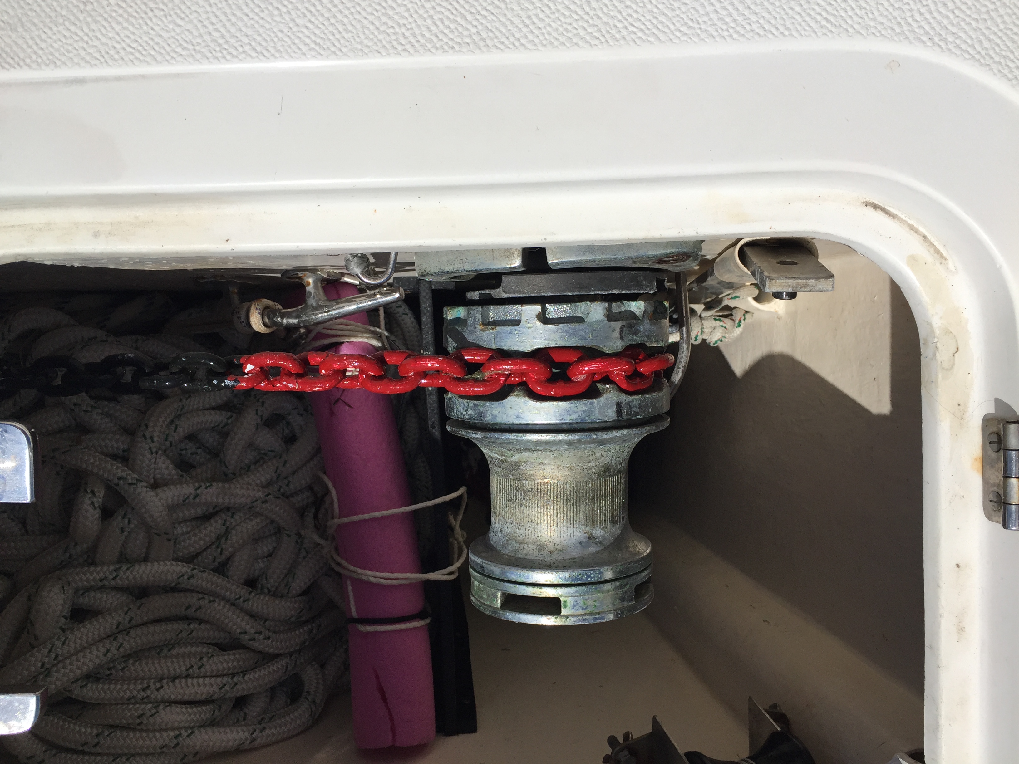 A segment of red chain in our anchor locker in the windlass of SV Aphrodite in George Town, Bahamas where we were marking our chain on the dock.