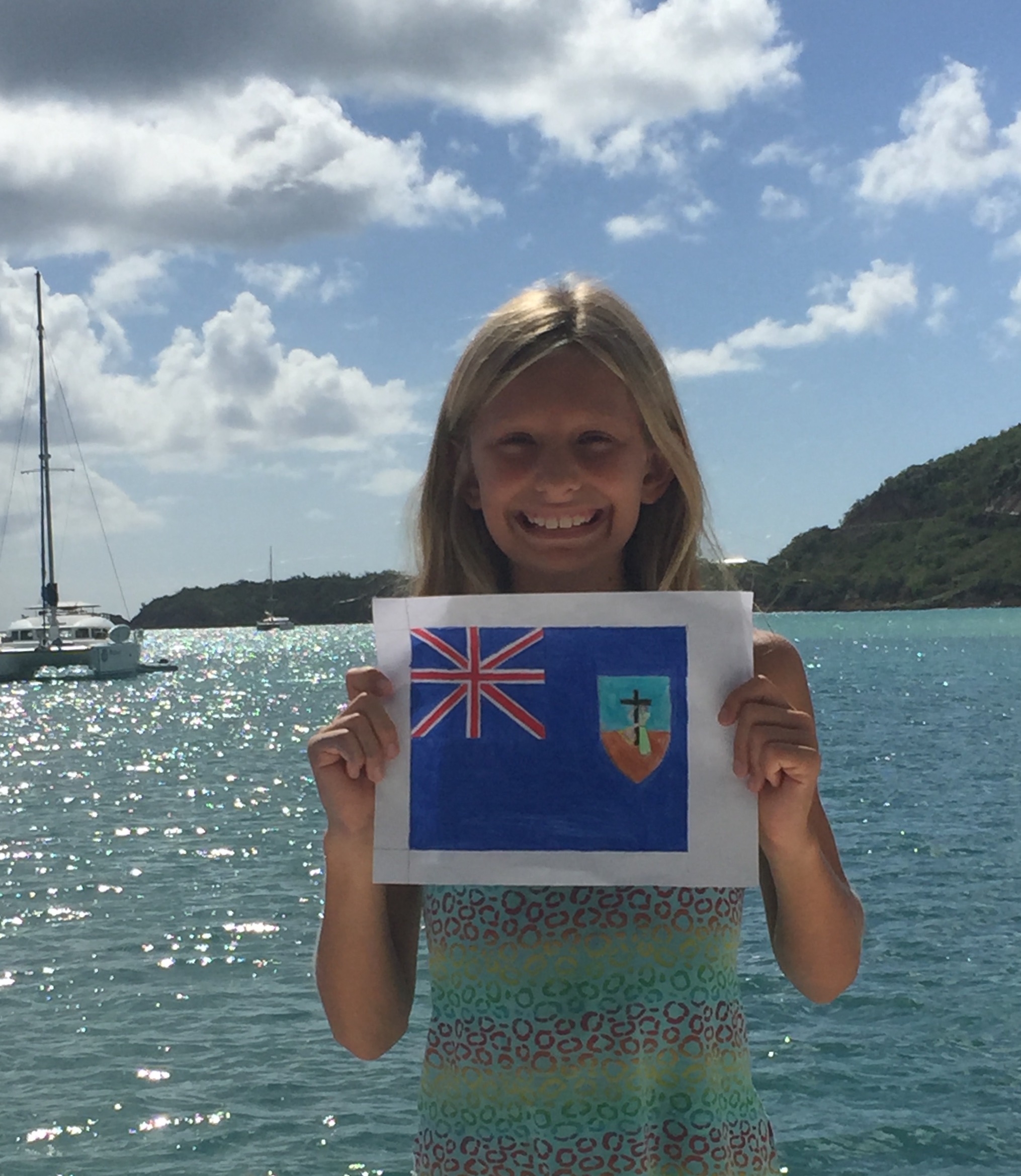 Betty with her hand-drawn Montserrat flag. Later, she laminated the flag and we flew it on our boat,, SV APhrodite, with pride.