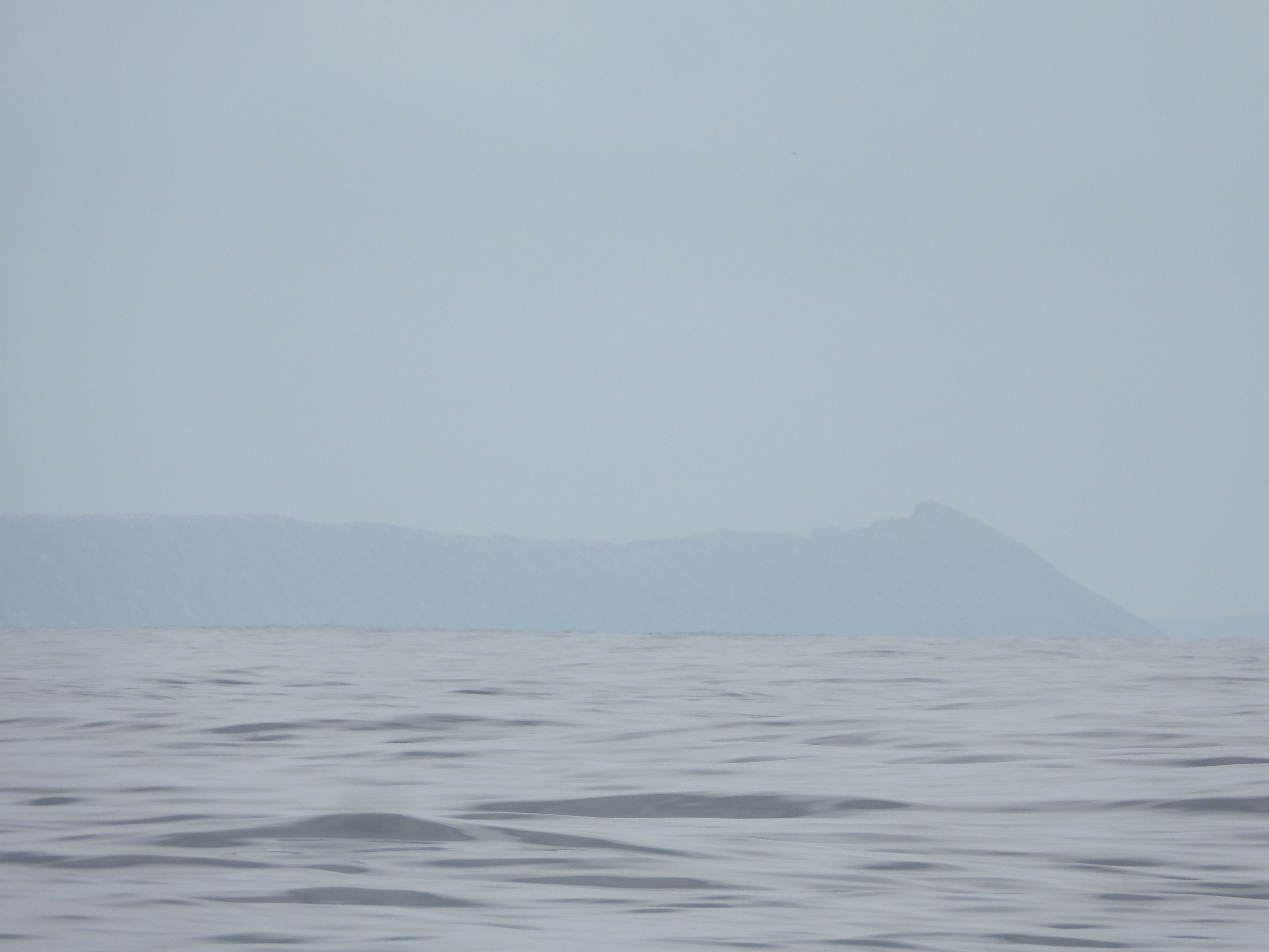 Volcanic Galapagos Island sighted from a distance after sailing weeks from Panama.