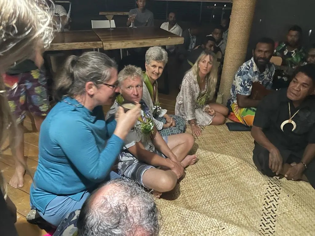 Lorraine accepts the Kava drink as a crowd looks on during a Fijian traditional sevusevu ceremony.