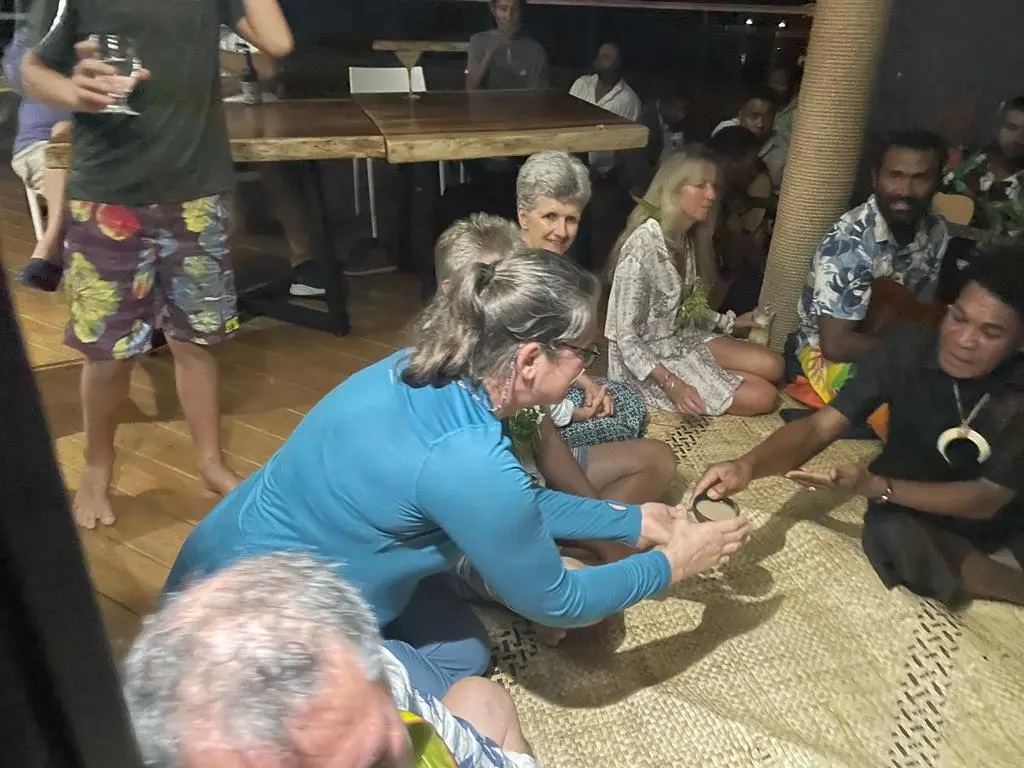 Lorraine is offered Kava drink from the chief during a Fijian sevusevu welcoming ceremony in Savusavu.