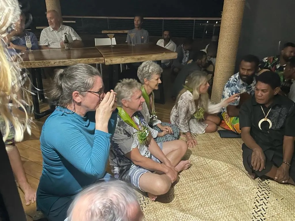 Writer, Lorraine Escher, takes first sip of the kava drink at the traditional Fijian sevusevu welcoming ceremony.
