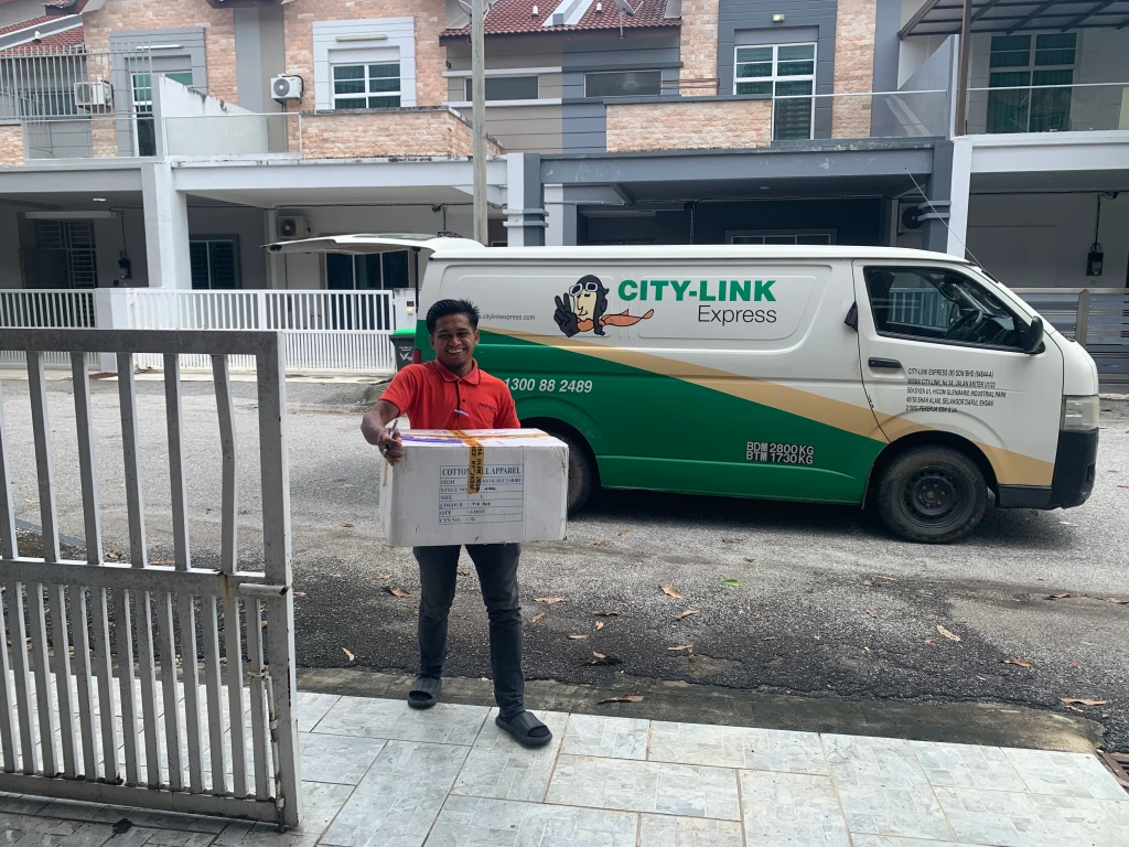 City-Link Express courier delivering the first of 3 boxes to a house in Langkawi.