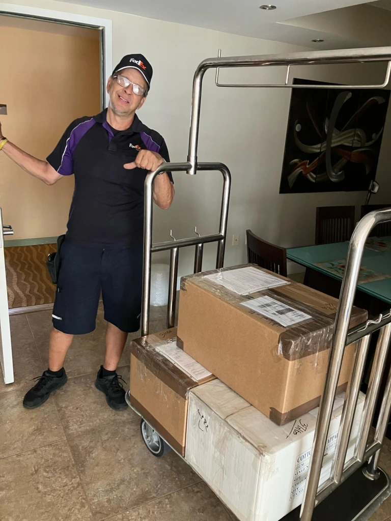 Fedex picking up our three boxes in our friend Carl's apartment in Miami.