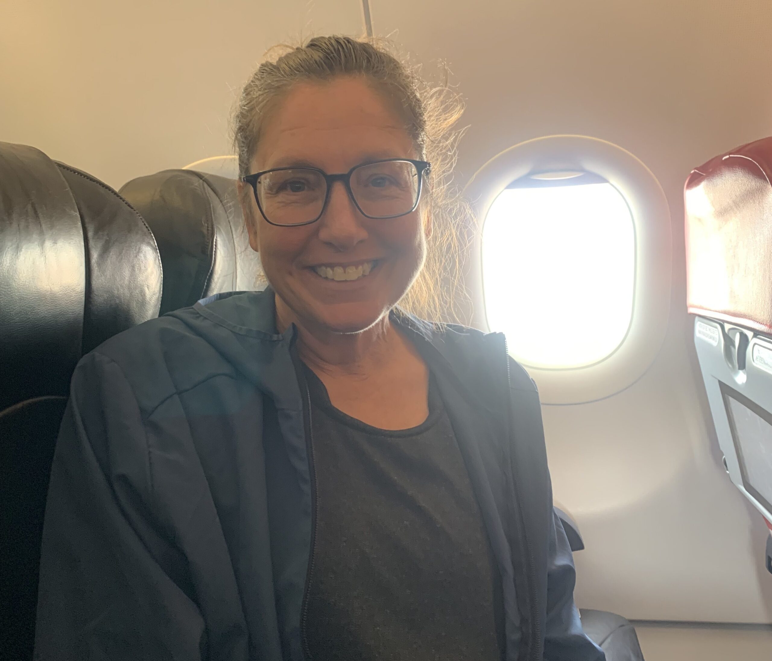 Lorraine Escher on a flight to Kuala Lumpur for trigger release surgery