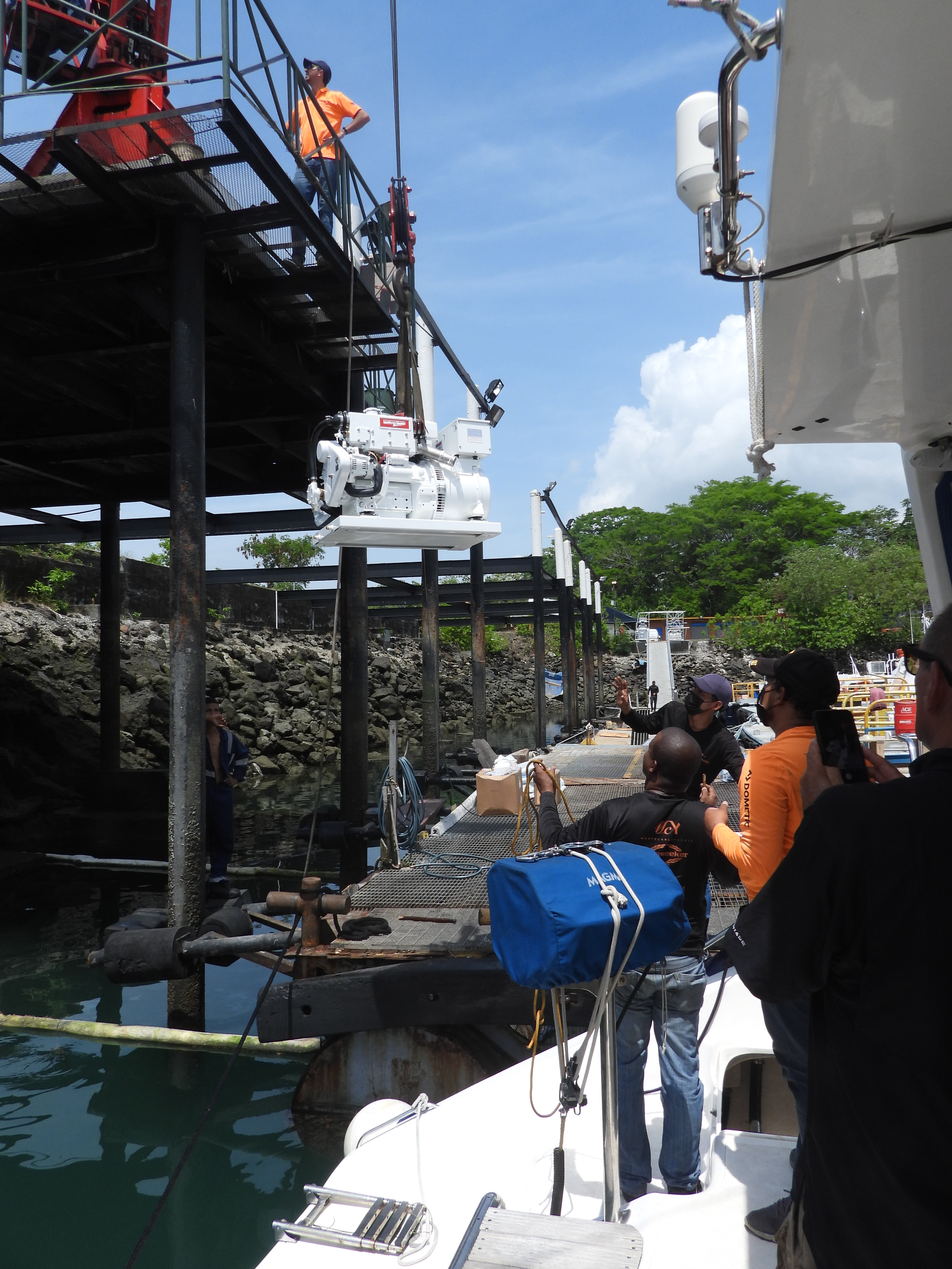 Crane lowers Northern Lights generator into a transom locker on the Canadian catamaran, SV Aphrodite.