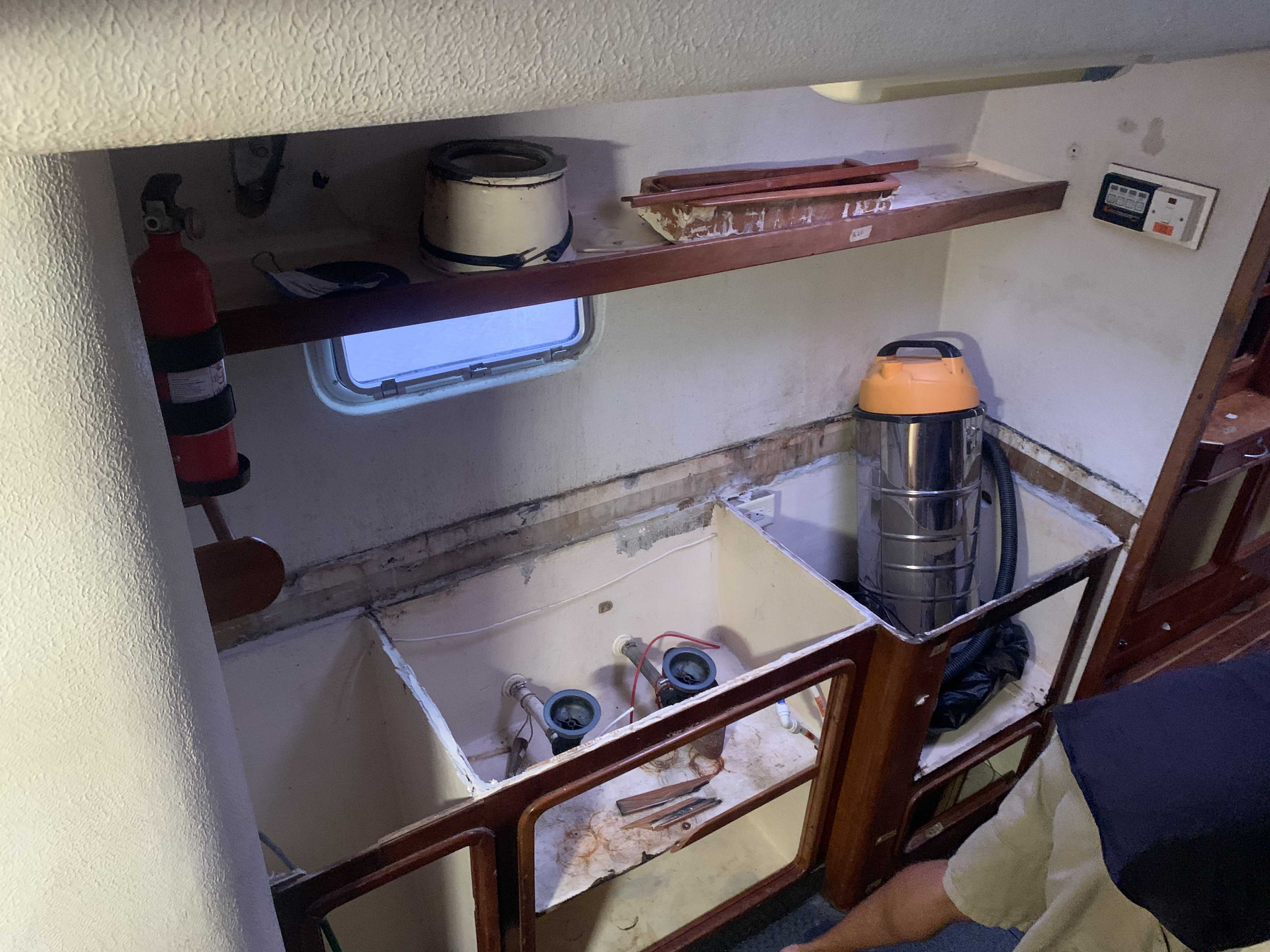 Galley of SV Aphrodite during a woodwork refit in Lunas Shipyard, Langkawi. The countertop, sinks, stove, oven and cupboard doors have been removed.