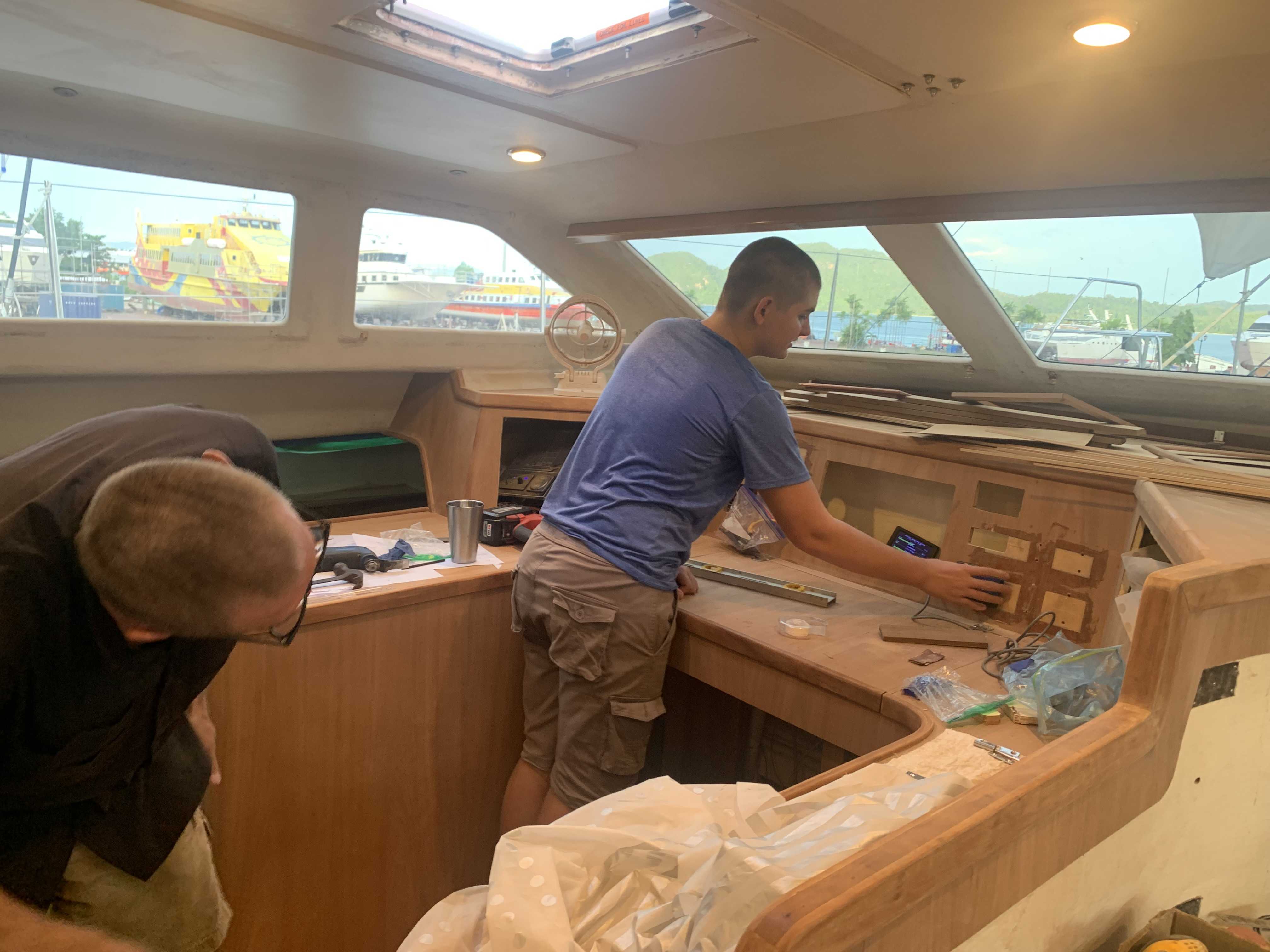 Henry is about to cut holes in the nav desk as Rick supervises with a watchful eyel