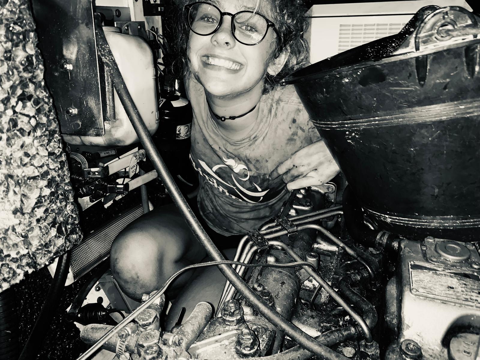 Karen Escher cleaning theport engine on SV Aphrodite, a St. Francis 50 catamaran.