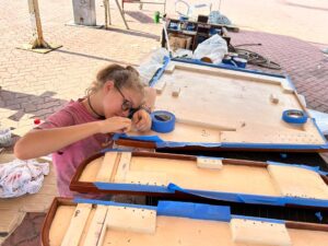 Karen painting the underside of our saloon table at Lunas Shipyard in Langkawi, Malaysia.