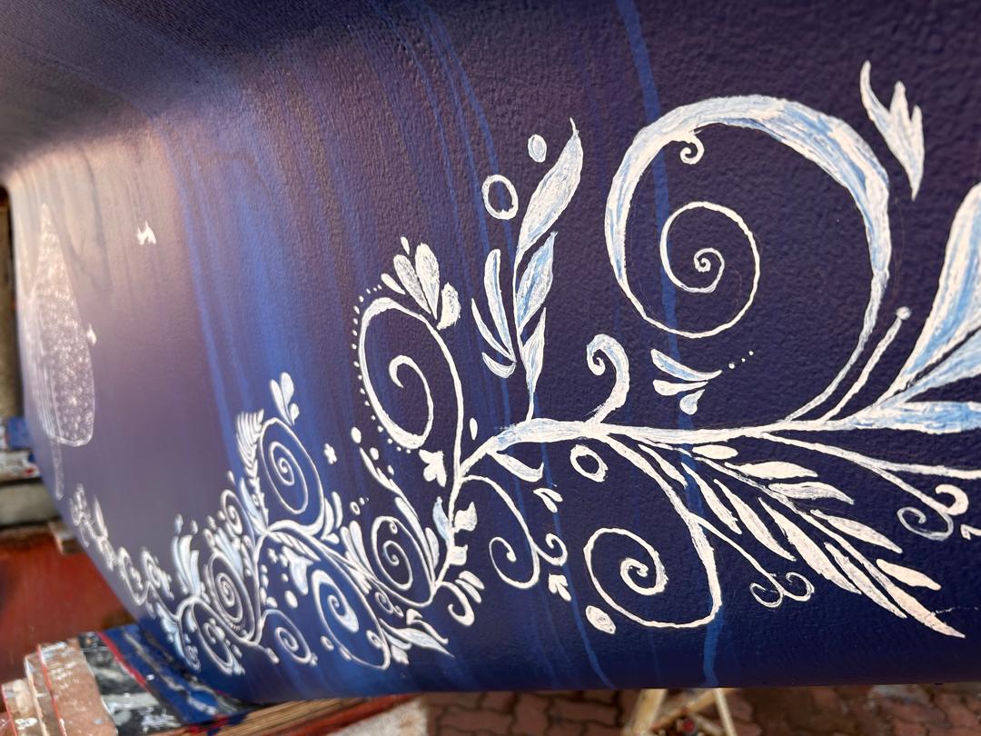 close-up photo of the scrollwork that Karen painted on the keel of our St. Francis 50 catamaran, SV Aphrodite