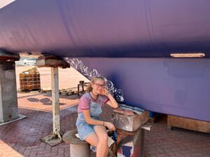 Karen Escher painting the keel in Langkawi, Malaysia.