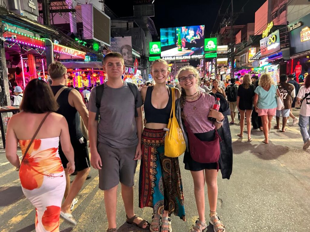 Henry, Betty, and Karen on Bangla Road flanked by go-go daners in the red-light tourist district of Phuket
