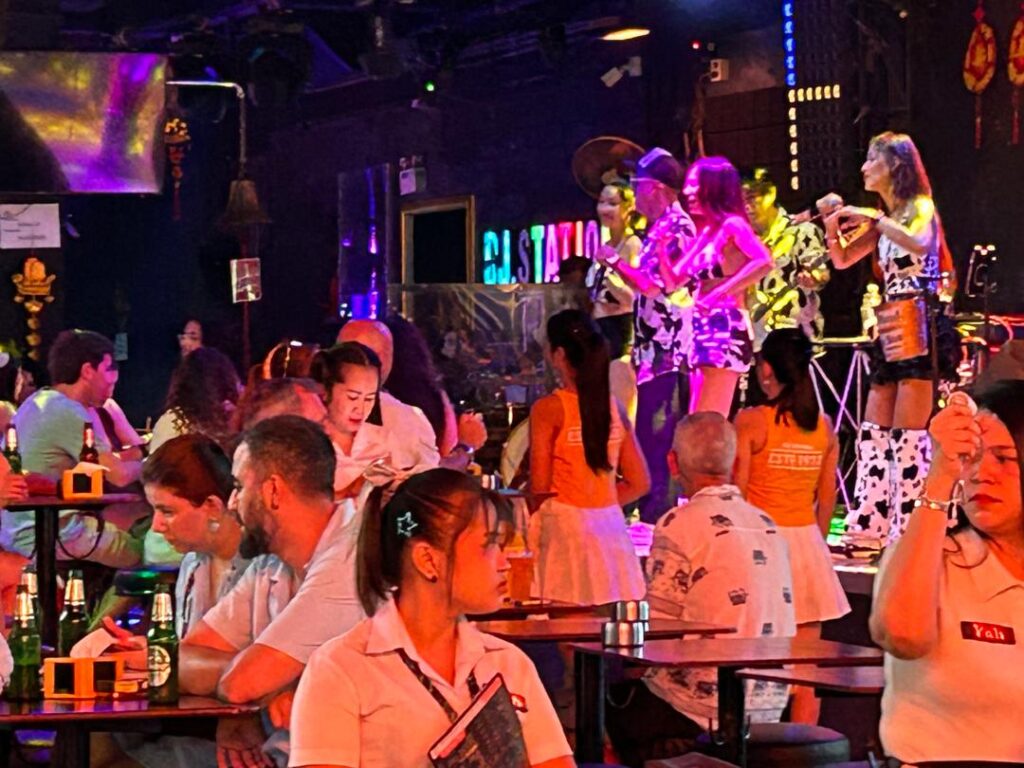 Singers wearing cow-patterned boots on Bangla Road, Phuket, Thailand