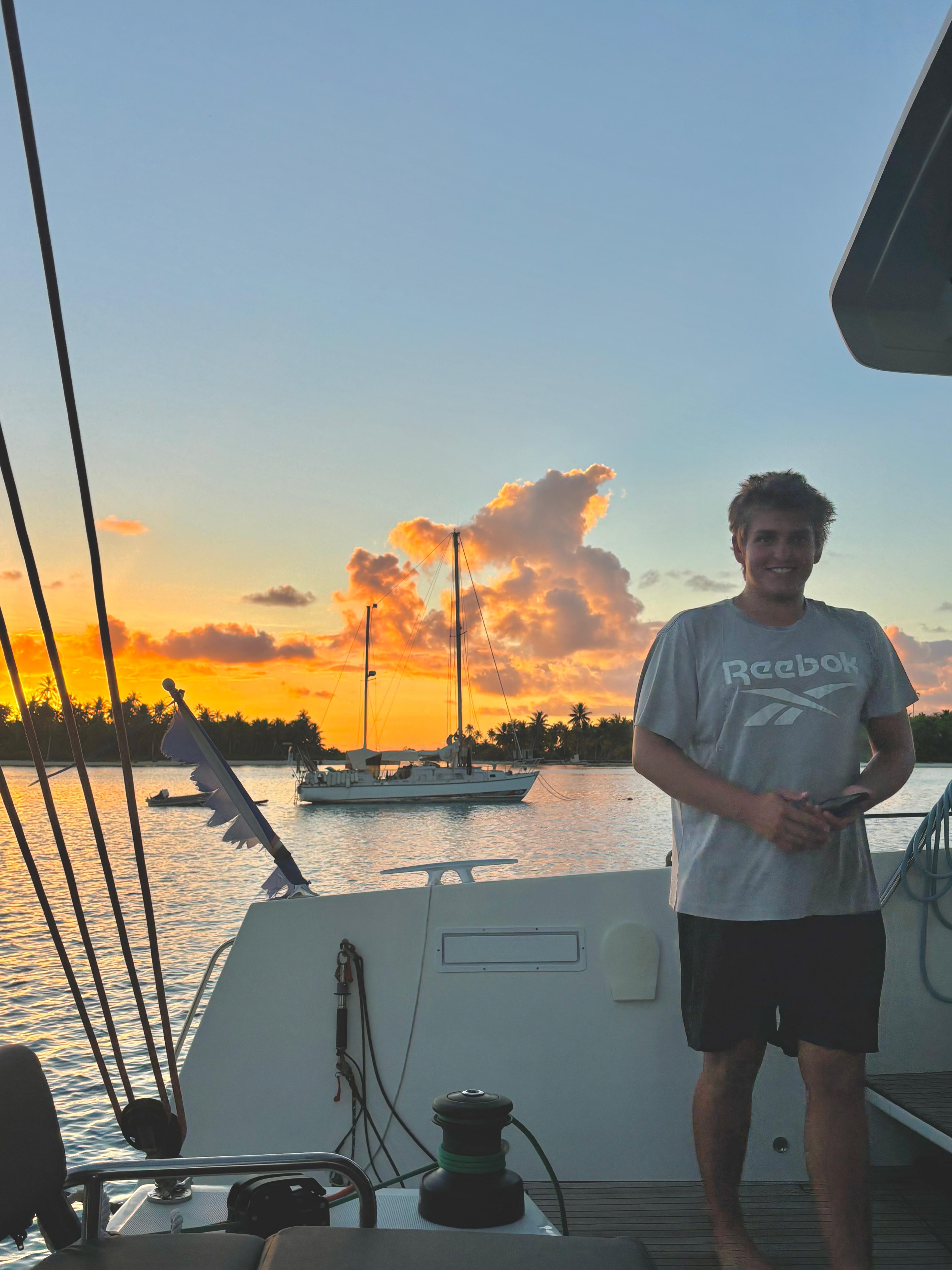 Boat kid and sailor, Paul Escher Age 18 at sunset in TikeHau, French Polynesia crewing on SV O'Vive, which is a Catana OC50 catamaran.